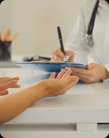 Chuyên gia ghi chép trên bìa kẹp hồ sơ trong lúc trò chuyện với thân chủ ngồi đối diện